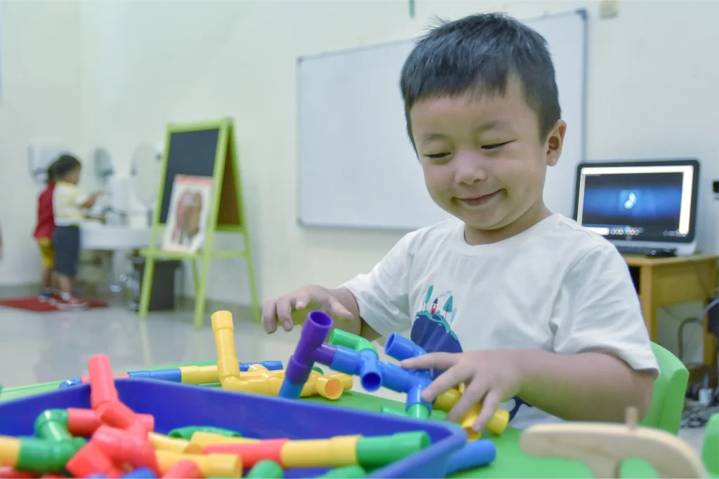 an early childhood education student is playing at Sekolah Victory Plus - The leading International Baccalaureate School in Indonesia