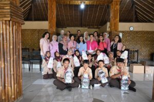 The Parent Support Group team posing together with the founder of Sekolah Kami and the children after the donation distribution.