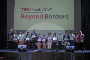 TEDxYouth@SVP speakers on stage, together with the Director and Management Advisor of Sekolah Victory Plus.
