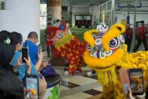 Parents enjoying the Barongsai (Lion Dance) performance in the lobby for the Lunar New Year Celebration at Sekolah Victory Plus, an International School in Bekasi.