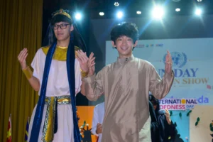 Two male students from Sekolah Victory Plus, an IB school near Jakarta, wearing Egyptian costumes as they walk down the runway during the school's United Nations Day celebration.