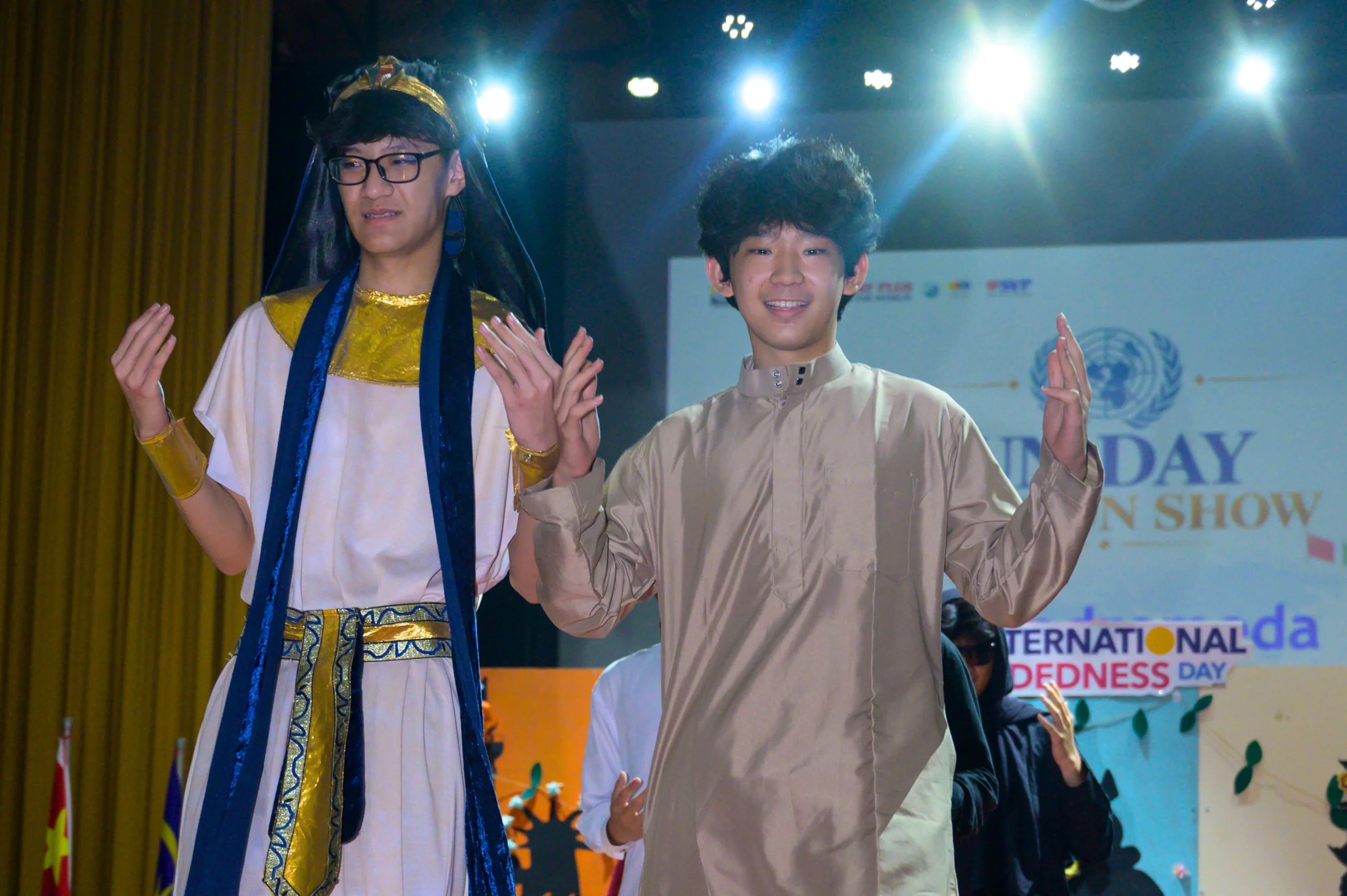 Two male students from Sekolah Victory Plus, an IB school near Jakarta, wearing Egyptian costumes as they walk down the runway during the school's United Nations Day celebration.